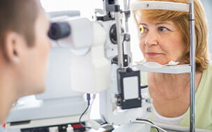 Senior caucasian woman having her eyes examined at the optician