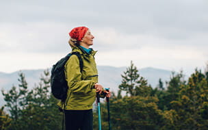 Middle aged woman going for a hike on top of the mountain range