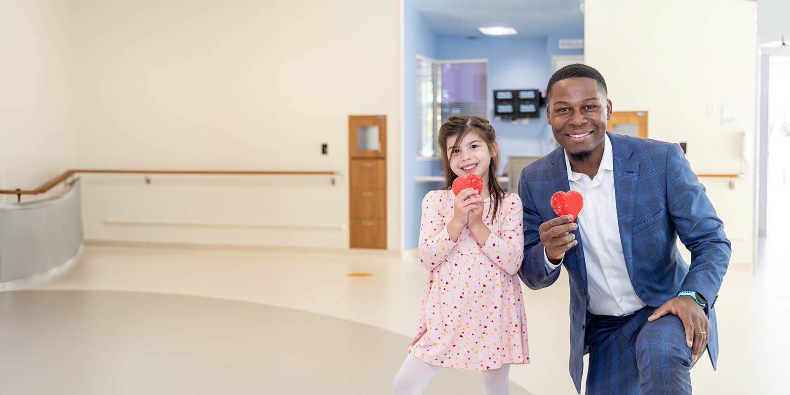 Doctor posing with patient in the Pediatric Cardiac Intensive Care Unit (PCICU) at UH Rainbow Babies & Children.