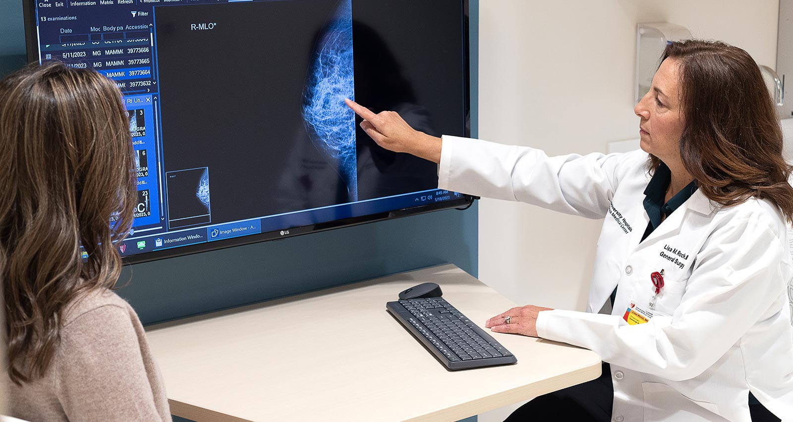 Lisa Rock, MD consults with a patient at the Breast Center at UH Ahuja Medical Center