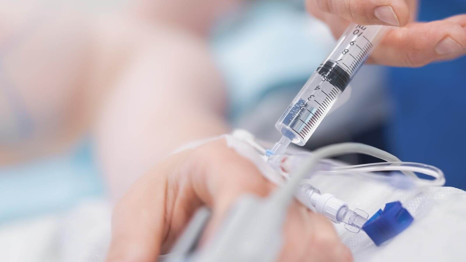 anesthesiologist administering medicine