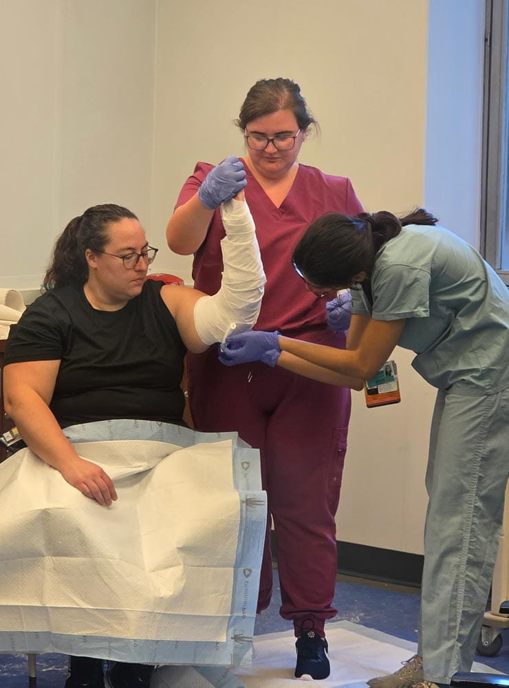 residents training on how to bandage an arm