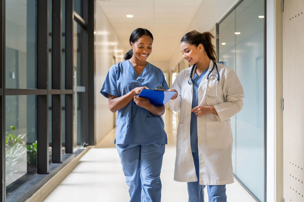 faculty and resident having a conversation in a medical hallway