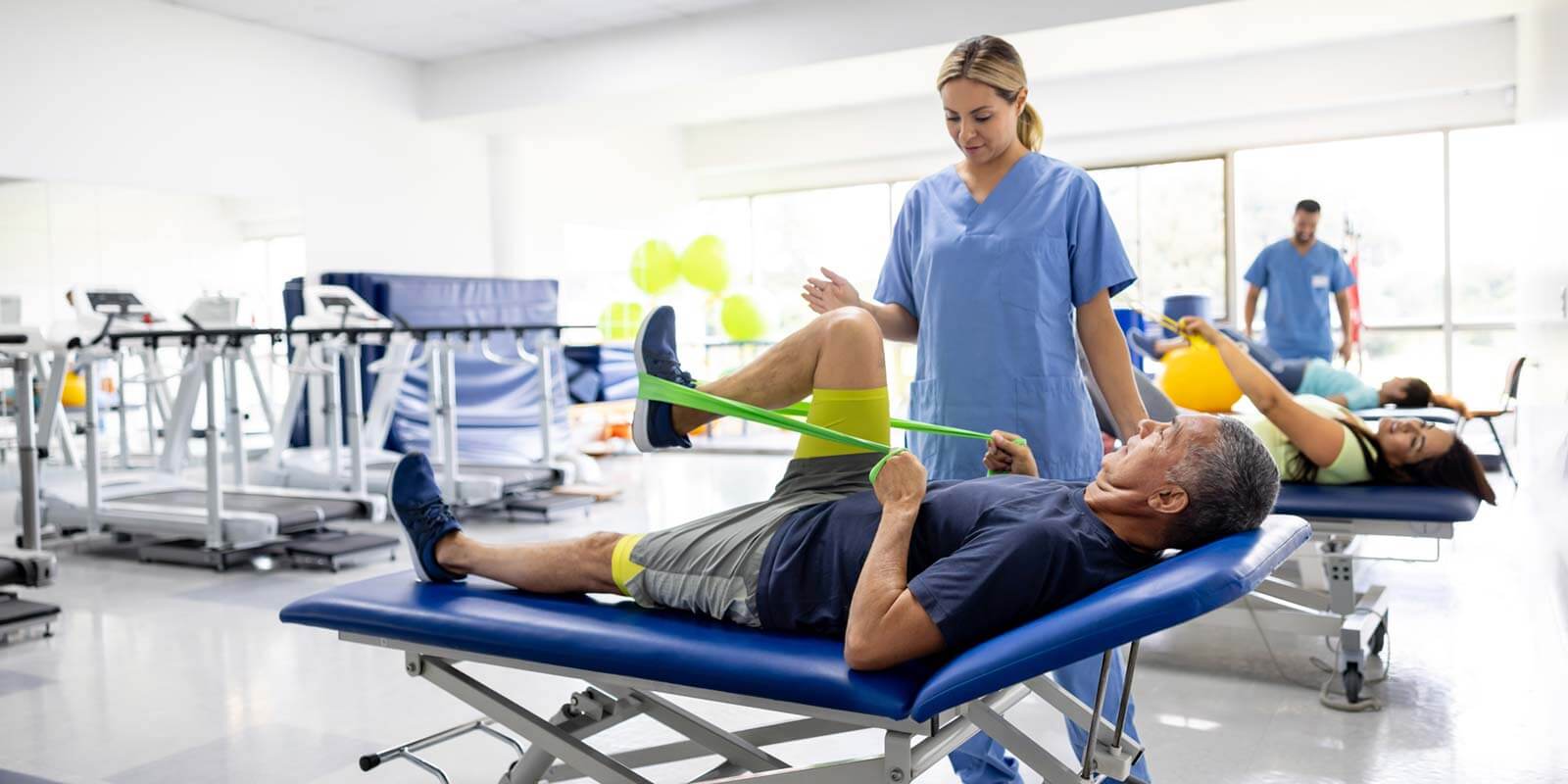 Man doing physical therapy exercises using a stretch band