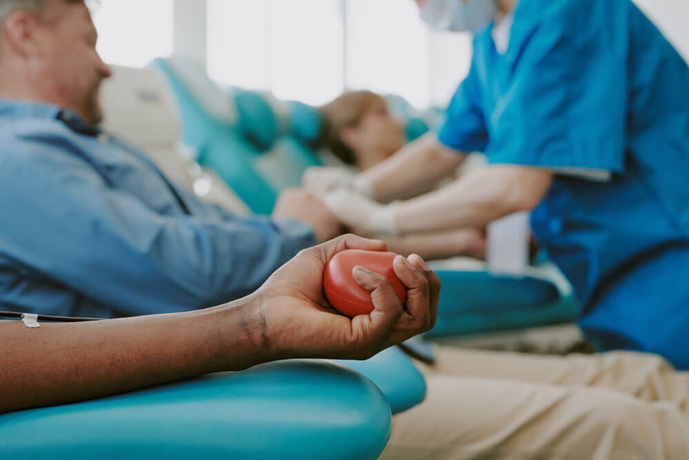 individuals donating blood at a blood center