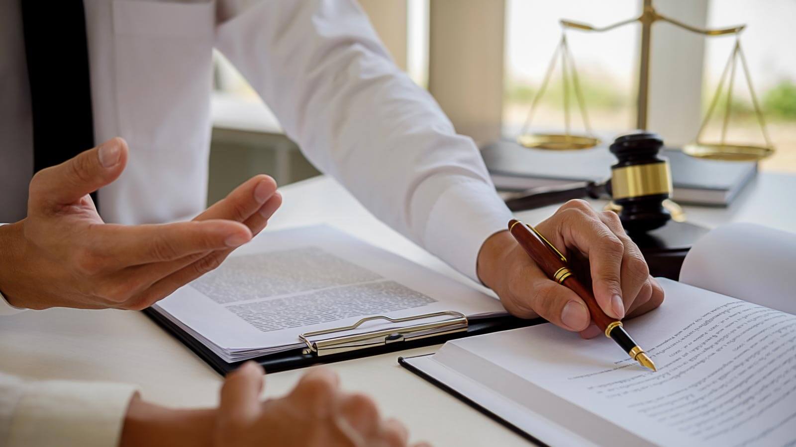 Legal counsel presents to the client a signed contract with gavel
