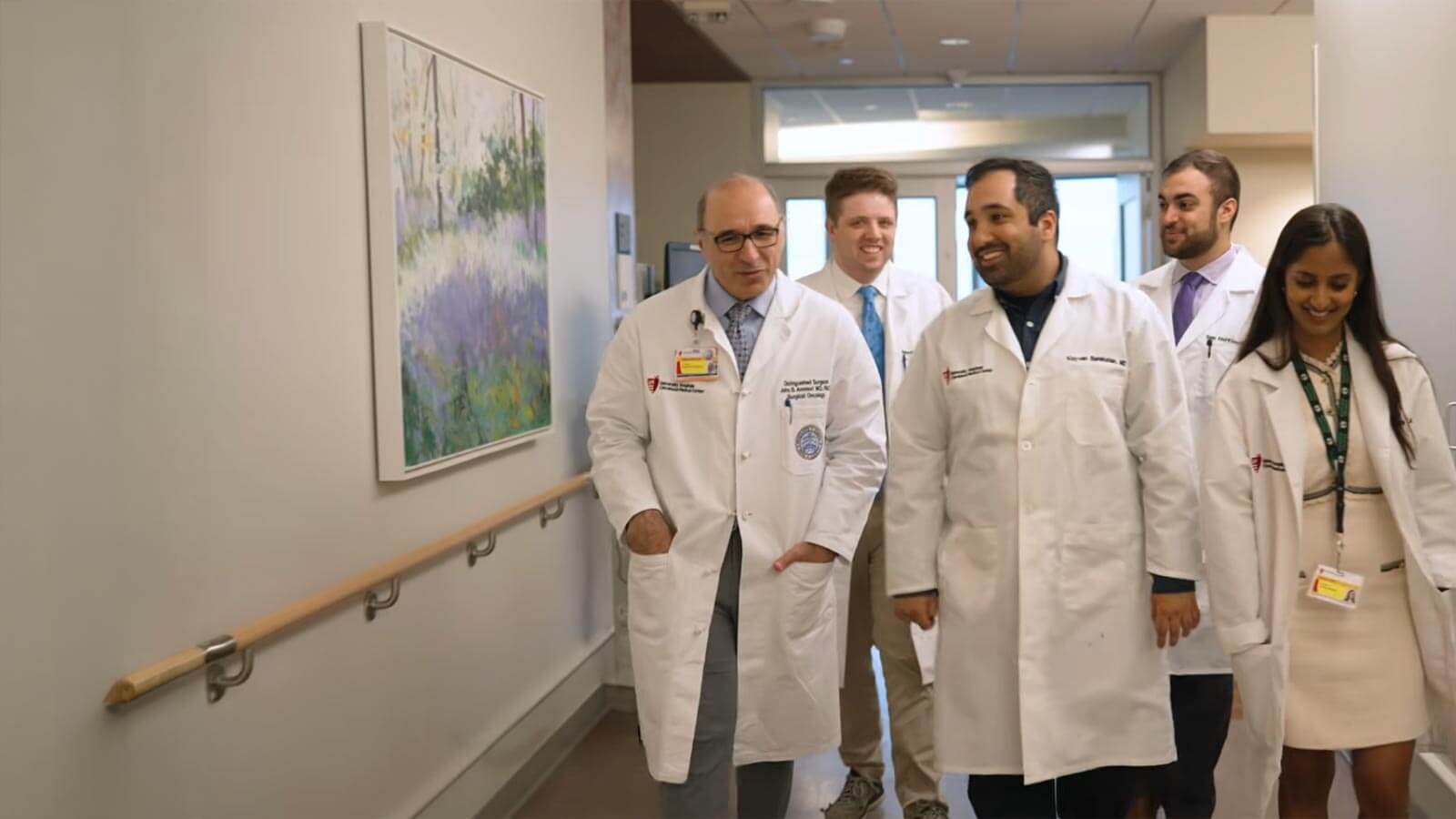program director and residents walking down hospital hallway