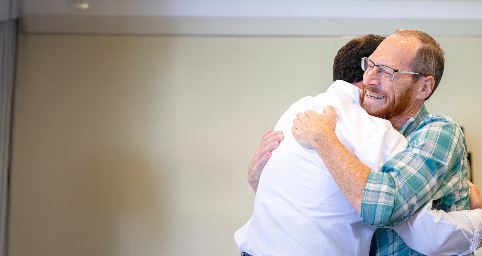 Jordan M. Winter, MD, hugs patient Scott Garson