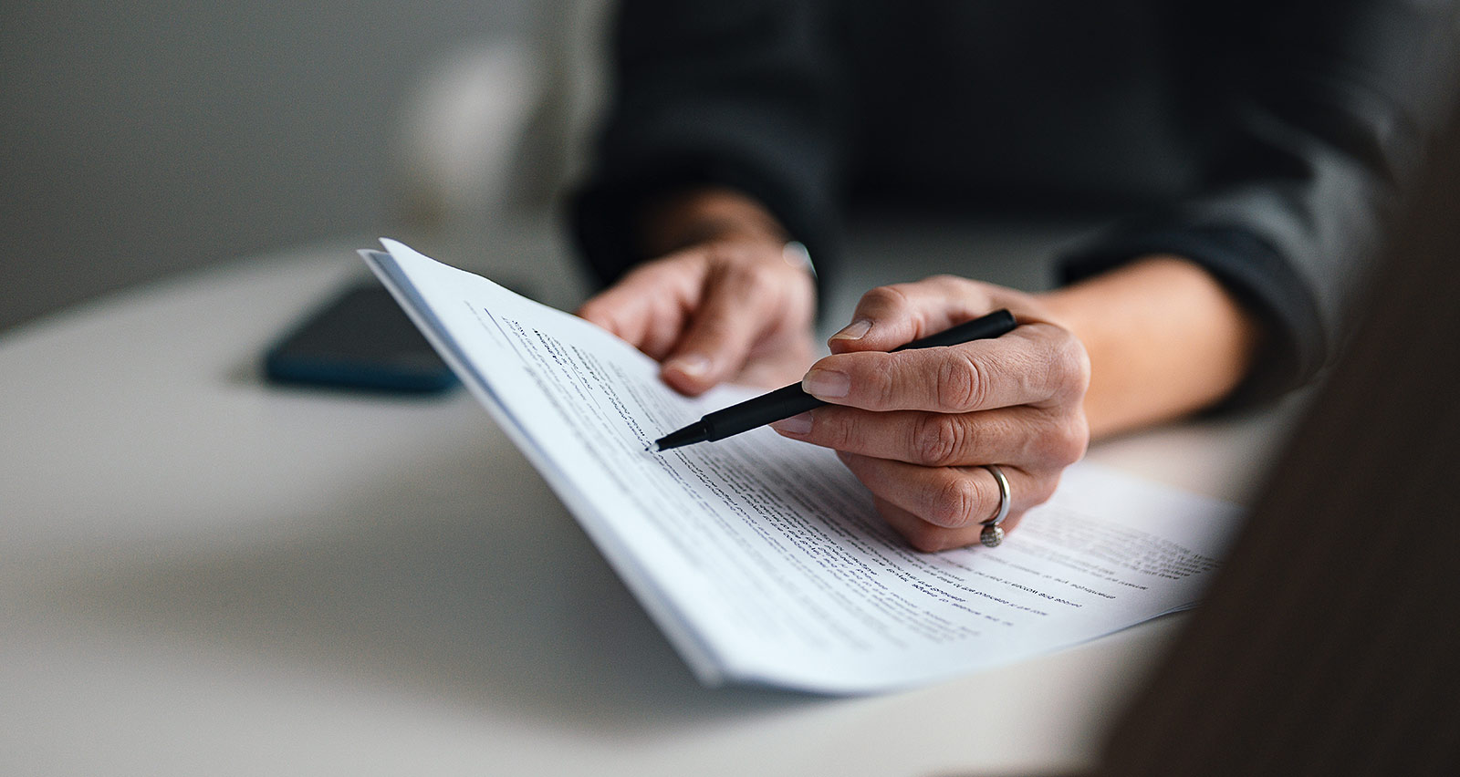 Close-up of hands holding and pointing to medical papers