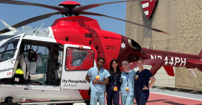 fellows standing in front of a UH helicopter