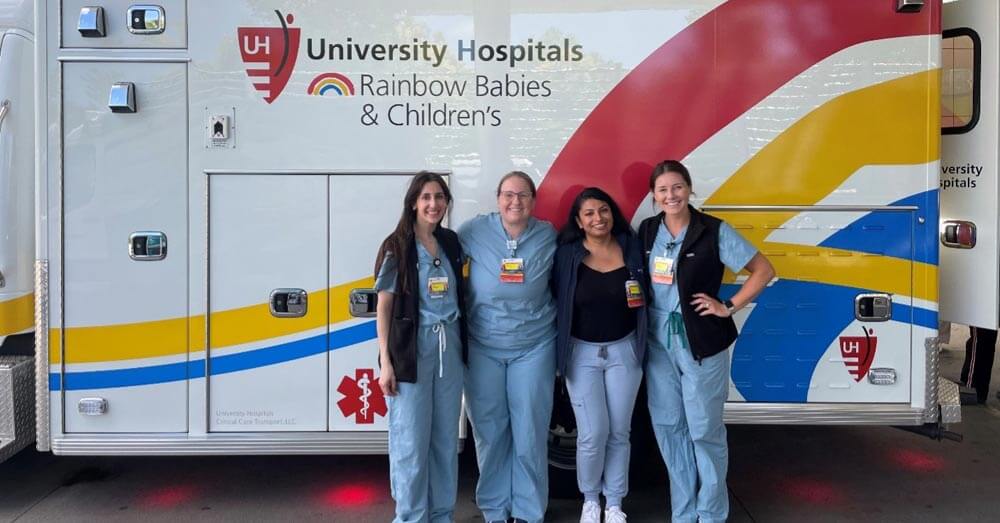fellows standing in front of a UH Rainbow ambulance