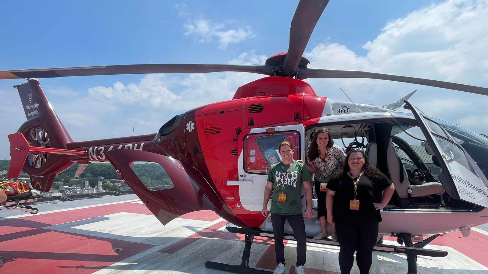 fellows standing by helicopter