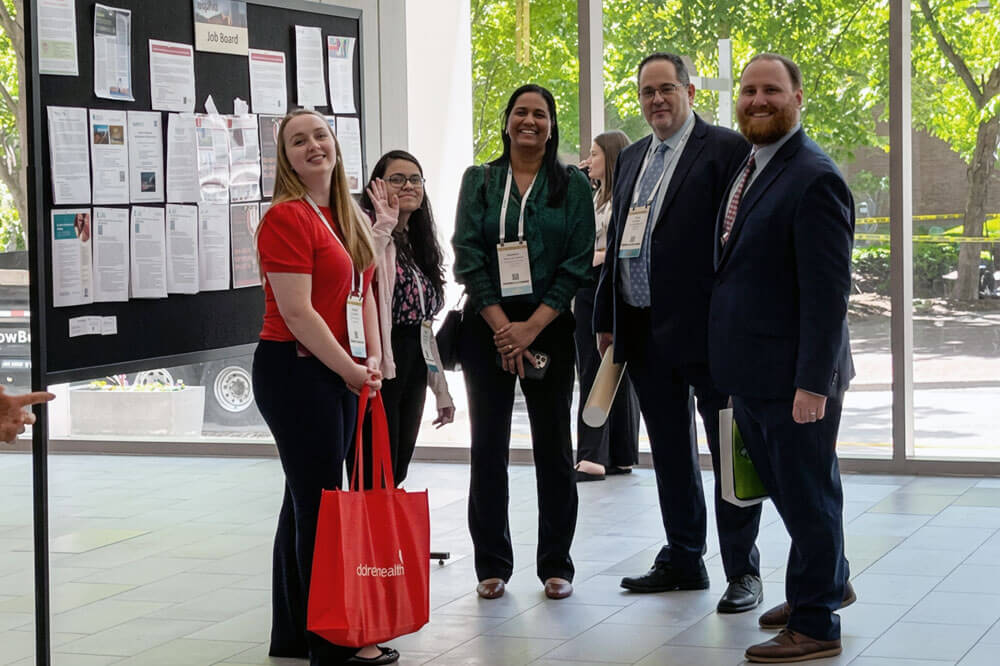fellows at a research conference with poster presentation