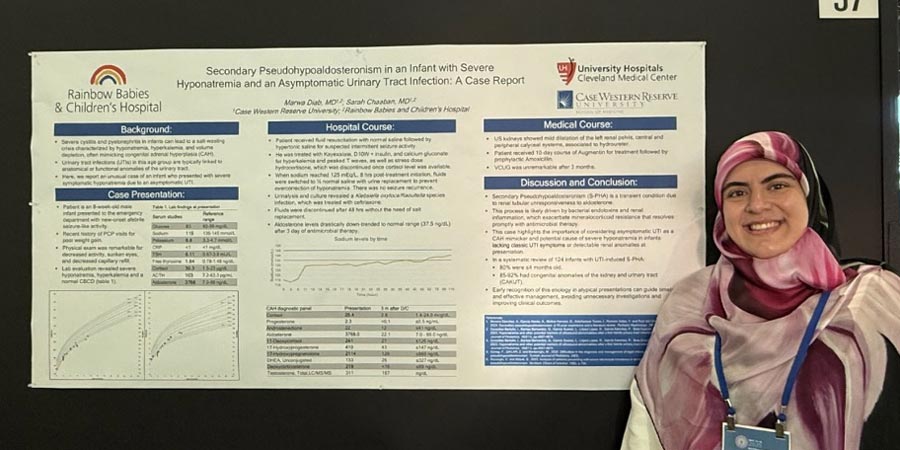fellows explaining her research poster