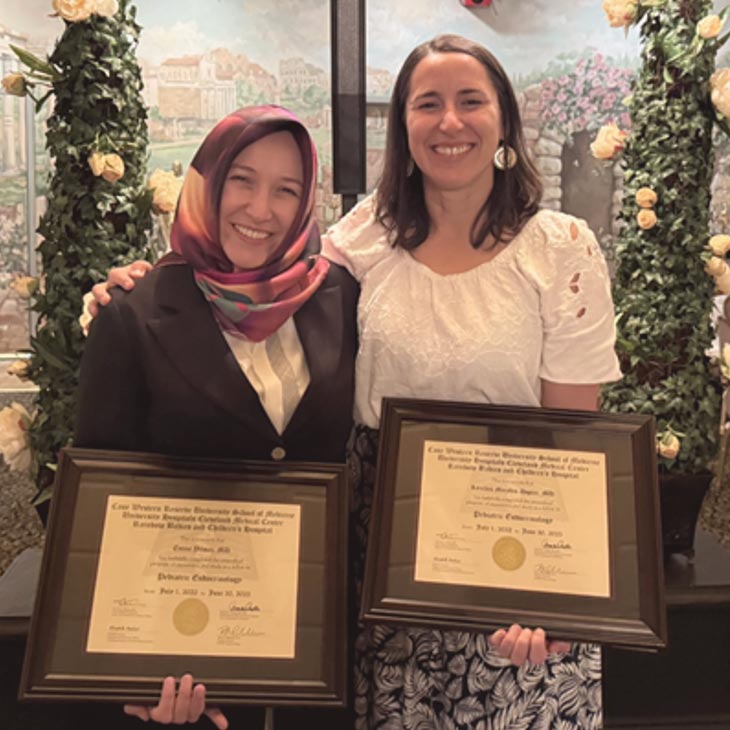 fellows displaying their diplomas