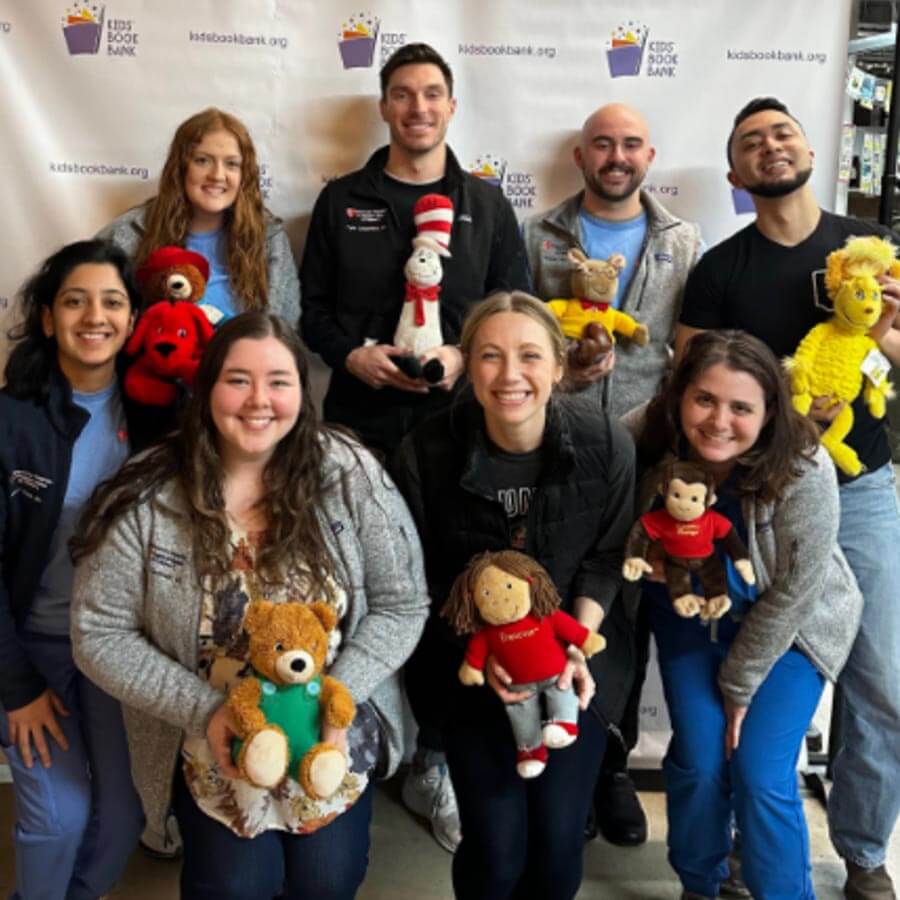 group of residents holding stuffed animals at the food bank