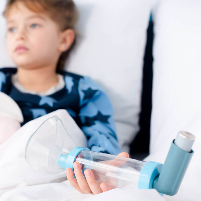 child holding inhaler