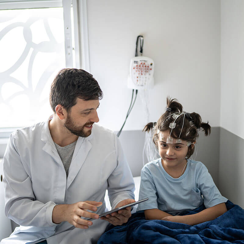 physician talking with child before sleep test