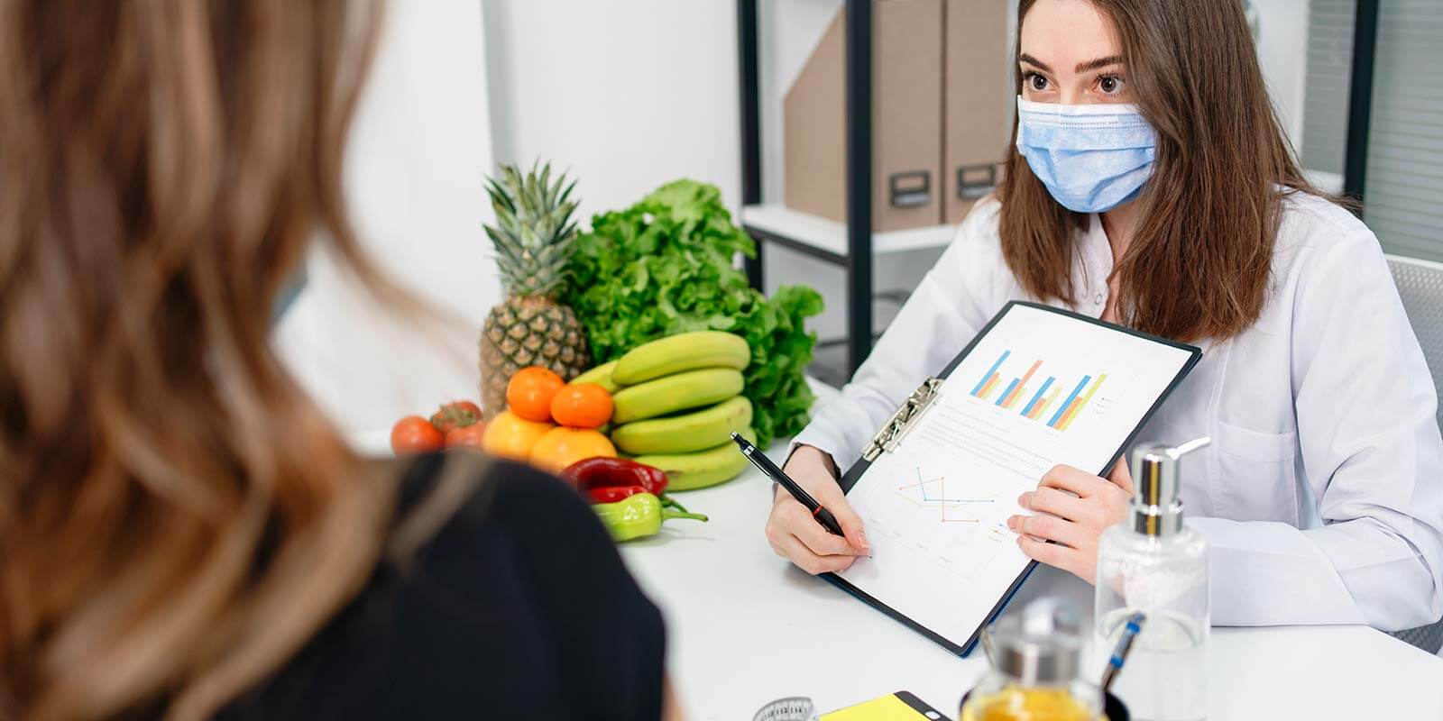 Dietitian holding diet plan during consultation