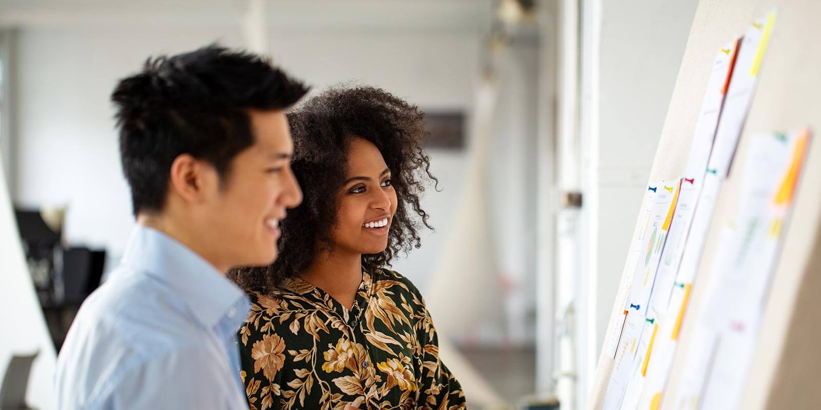 colleagues reviewing white board