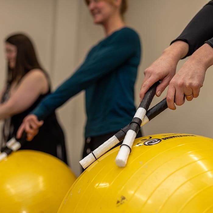woman using drum therapy