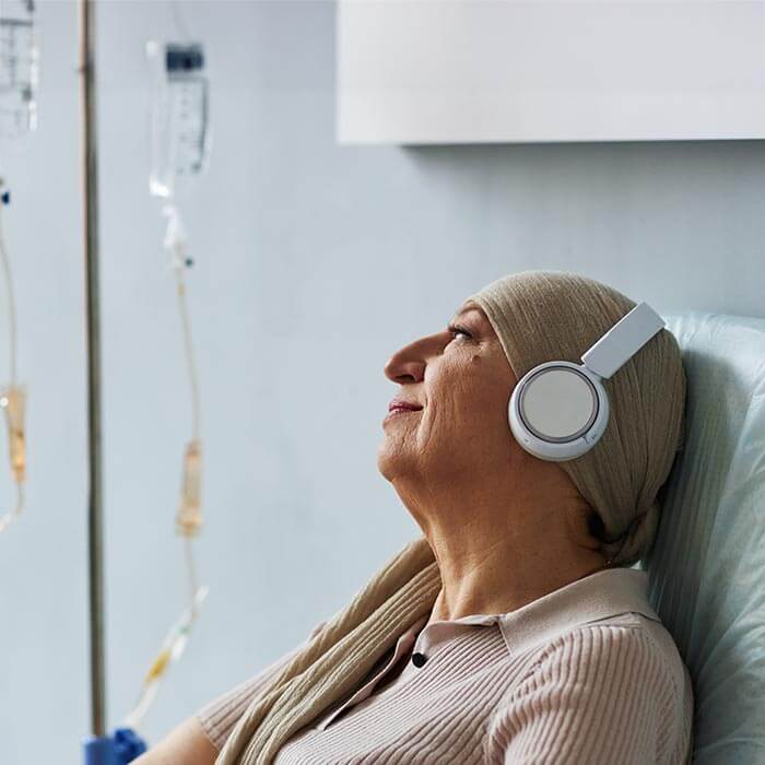 woman getting cancer therapy listening to music