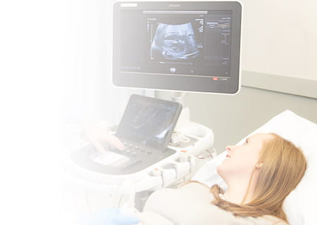 Expectant woman watches heart monitor