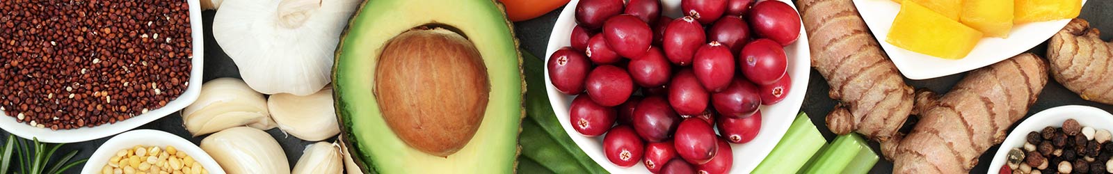 Mother and daughter eating a variety of fruit.