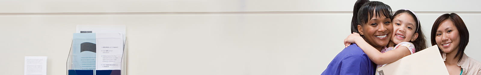 Medical staff helping child navigate hospital.