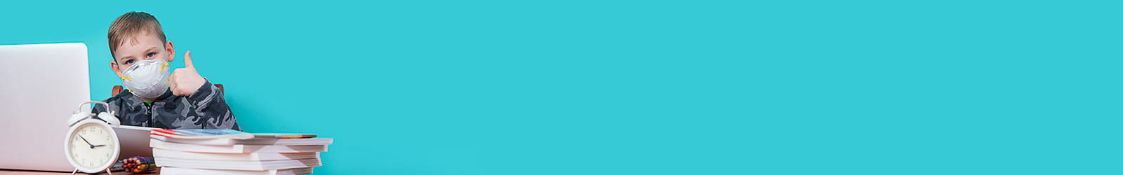 Young boy wearing mask and doing homework in hospital