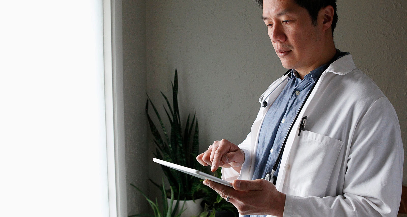 A medical professional using a digital tablet for diagnosis
