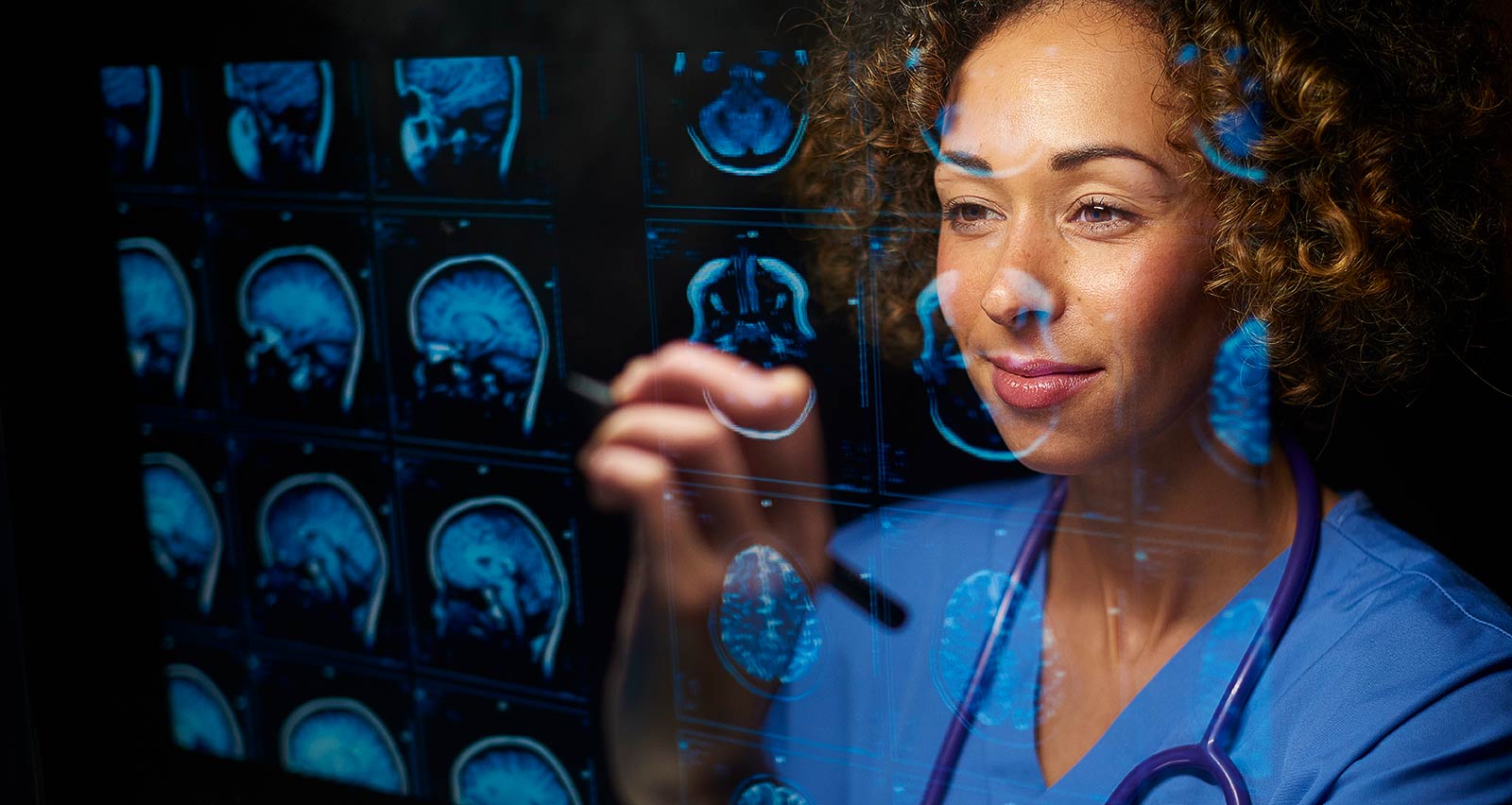 A female doctor is analysing digitally generated brain scans