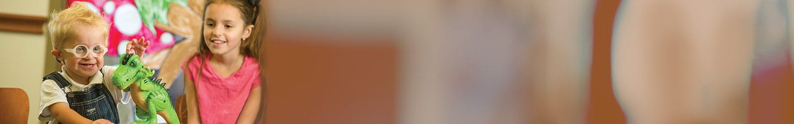 Carson Locher, UH Patient, playing with a toy.