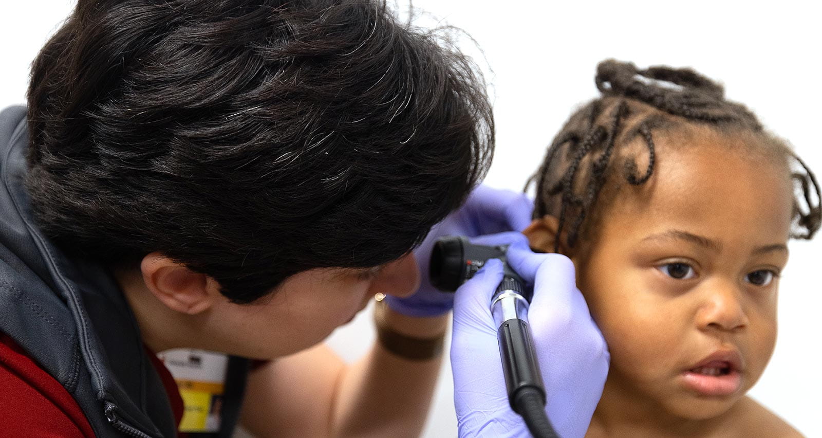 An infant receives an ear exam at UH Rainbow Ahuja Center for Women & Children