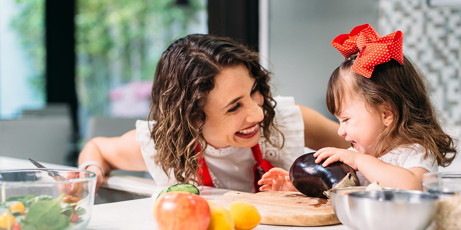 Mother and daughter cooking a healthy meal together in the kitchen