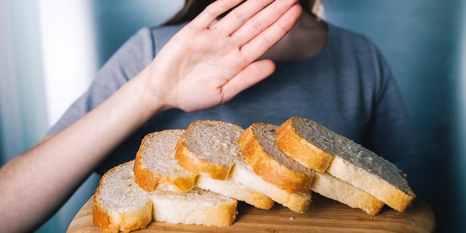 Young girl refusing to eat white bread