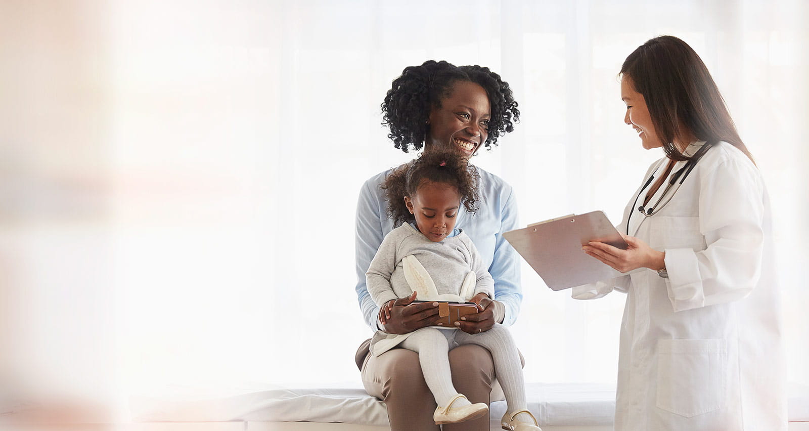 Doctor talking to a mother holding her daughter