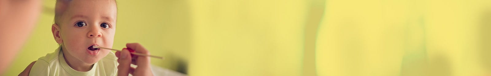 A baby's mouth being swabbed with cotton for DNA.