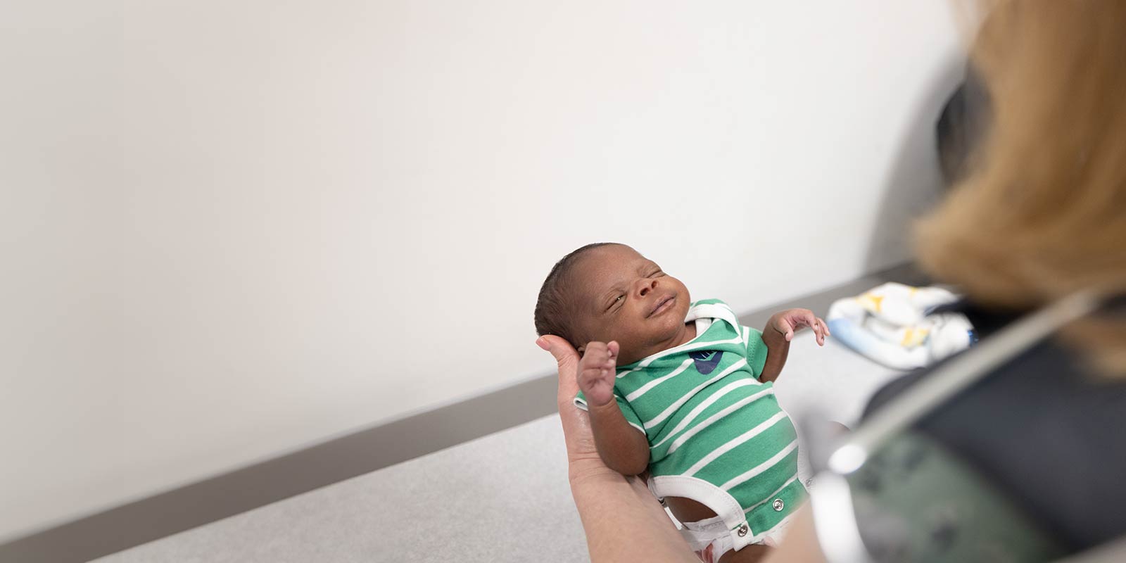 Doctor with male infant patient in office.