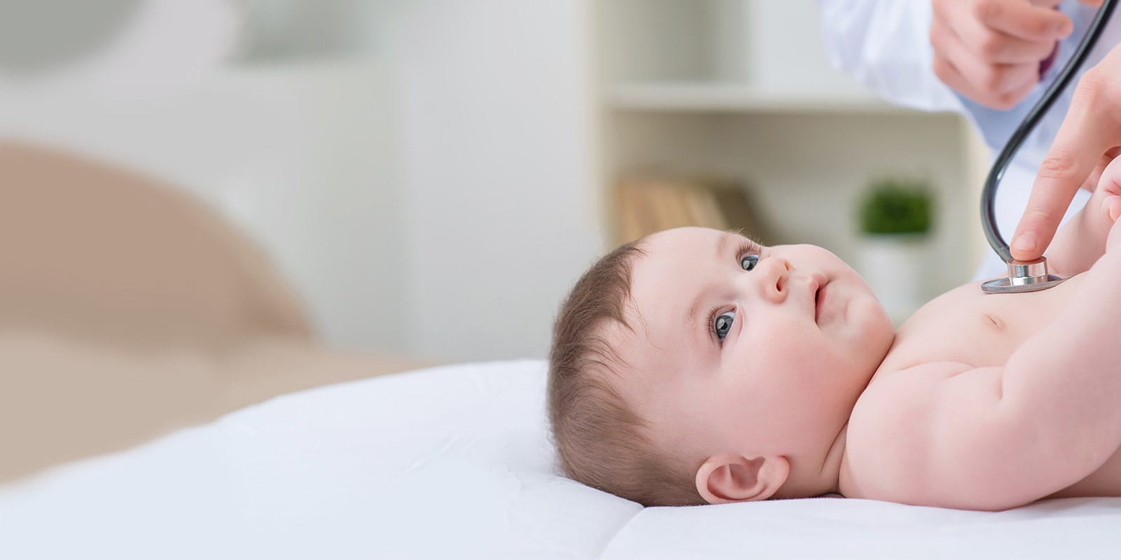 Doctor listening to child's heartbeat.