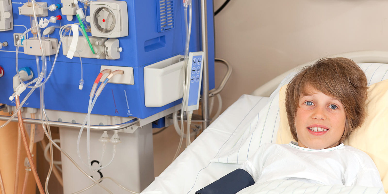 Young boy in hospital bed on dialysis station