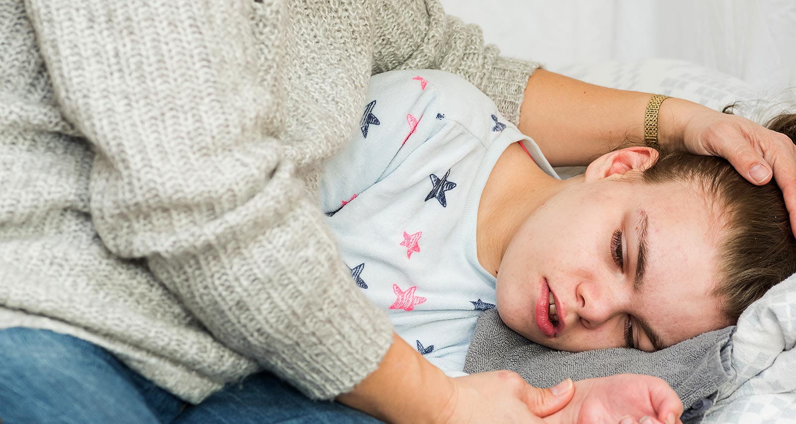 A child being cared for during an epileptic seizure by a qualified special needs carer