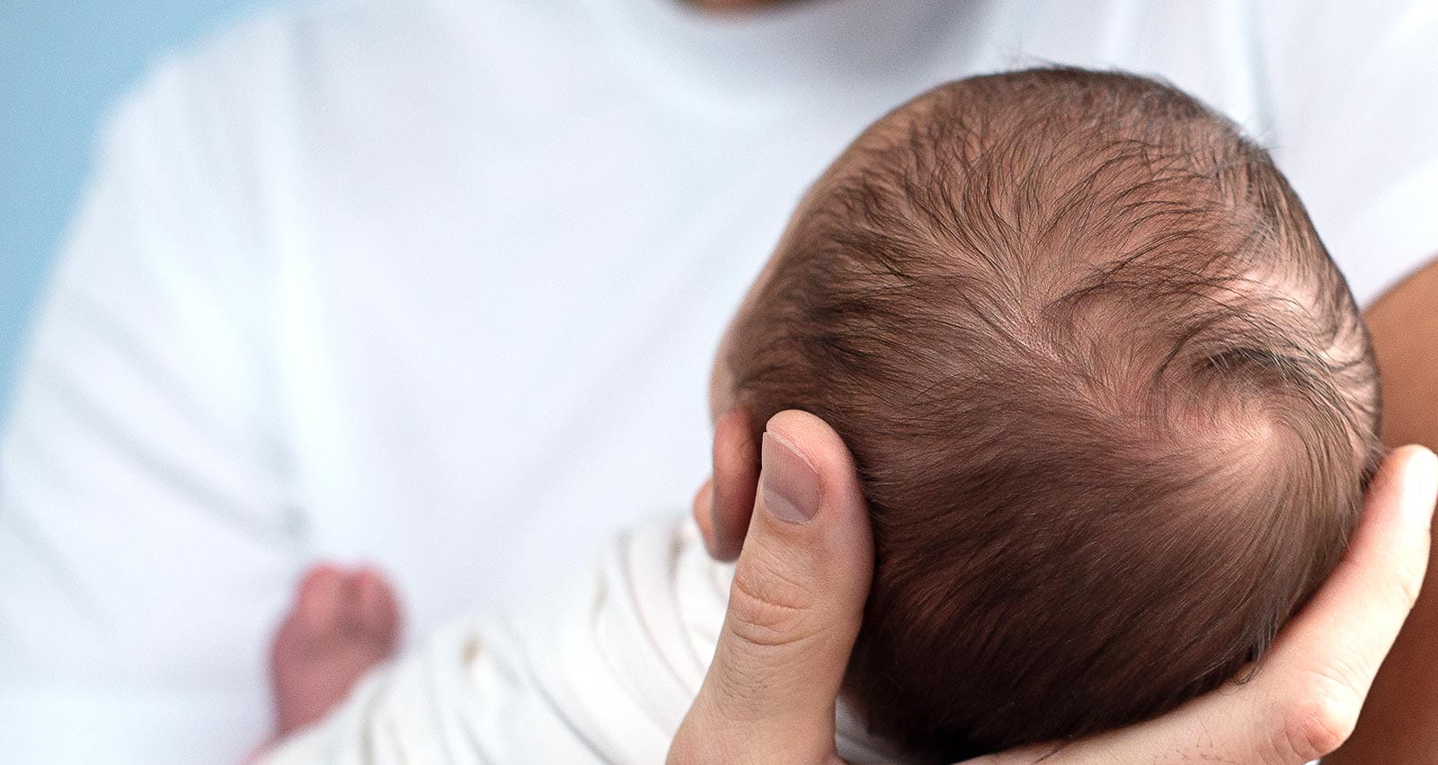 A father holding a newborn baby