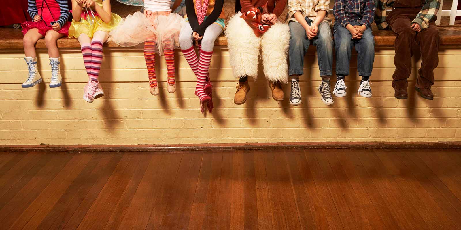Children sitting on edge of theatre stage