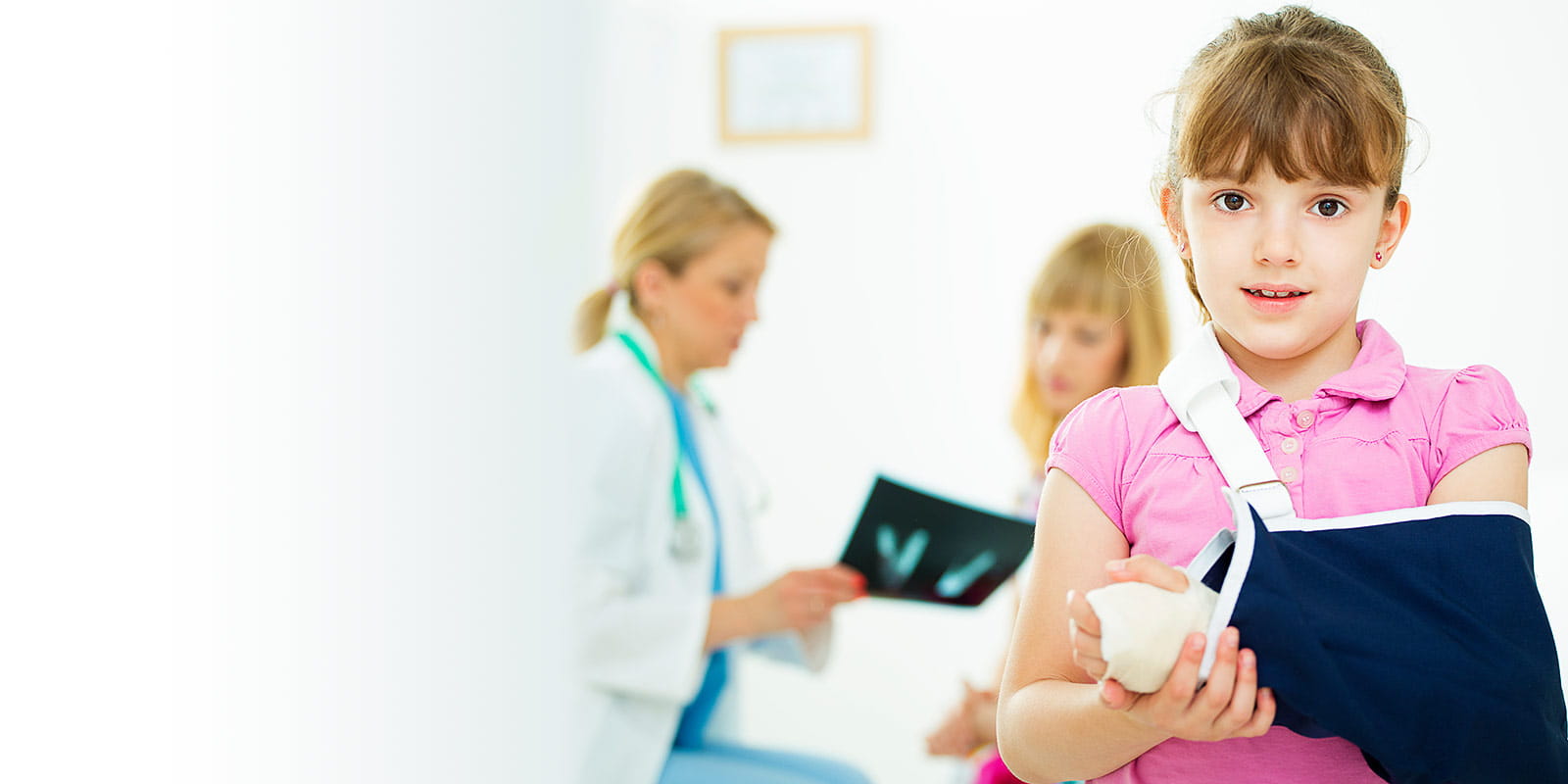 Provider, mother and daughter with broken arm at doctor's office
