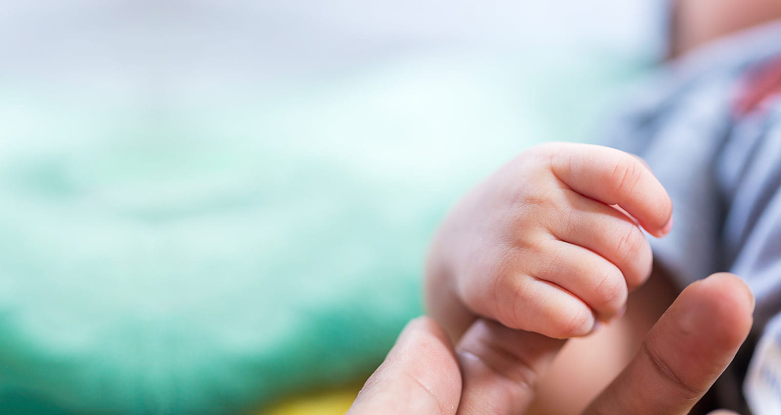 A baby’s hand in mother's hand