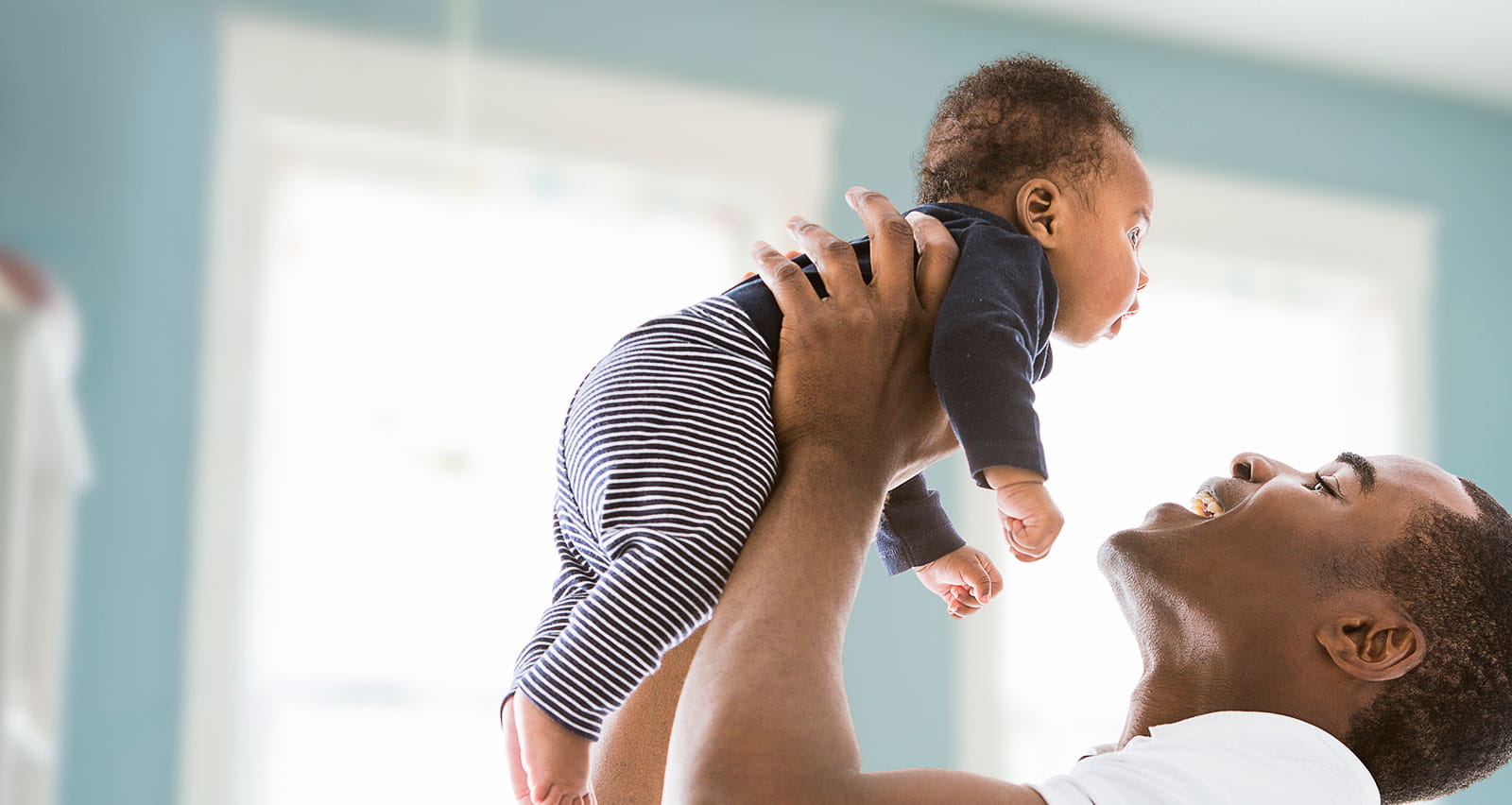 A father lifting his infant son