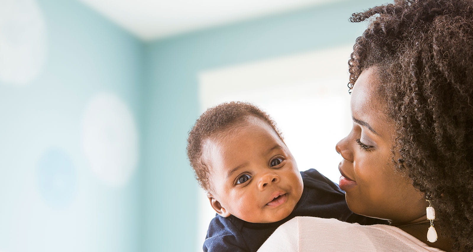 A mother carrying her infant son