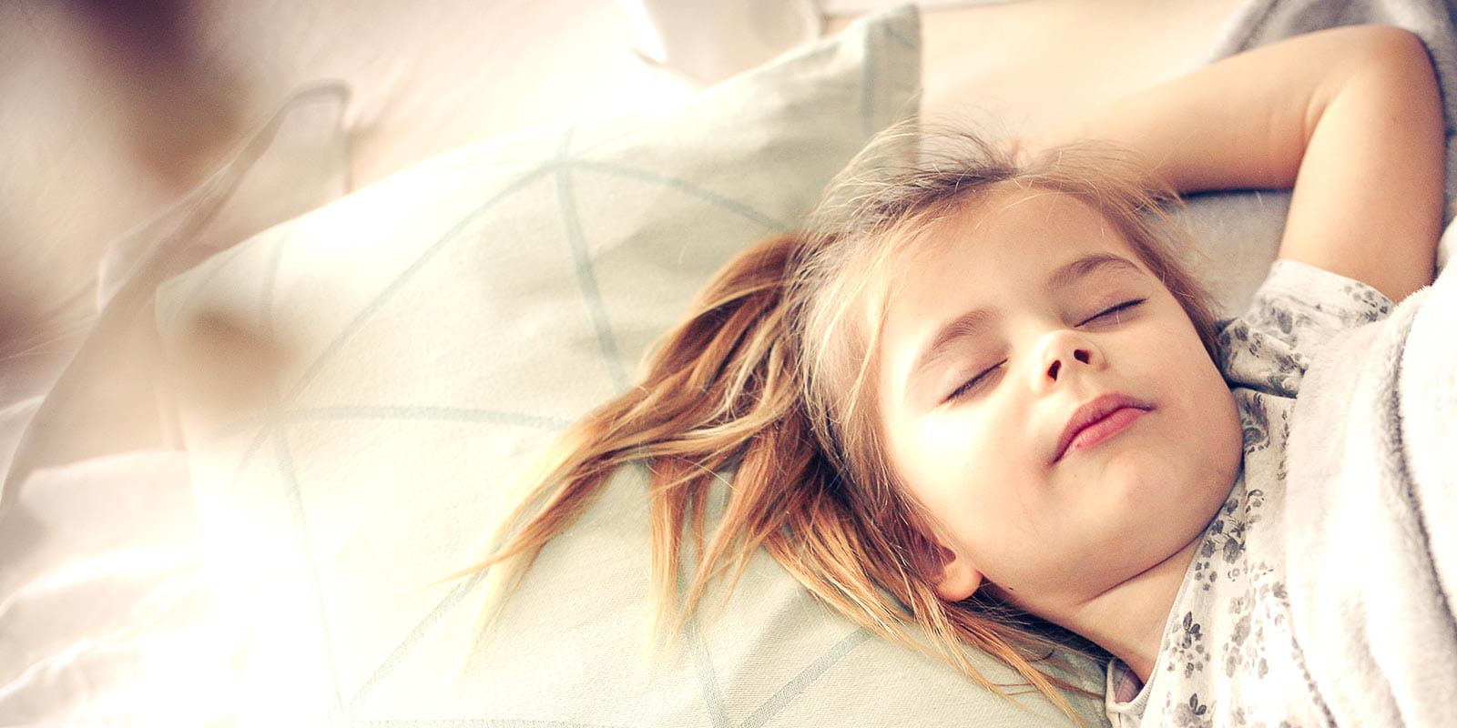 Little girl sleeping in bed.