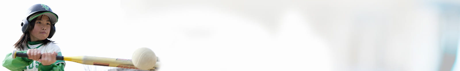 Girl playing baseball hitting the ball.